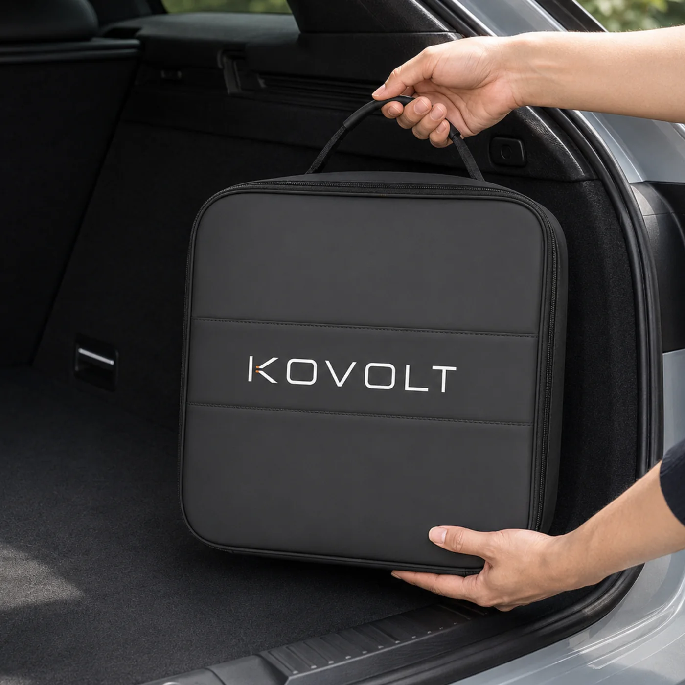 The Kovolt Case being lifted by its handle into the boot of a car.