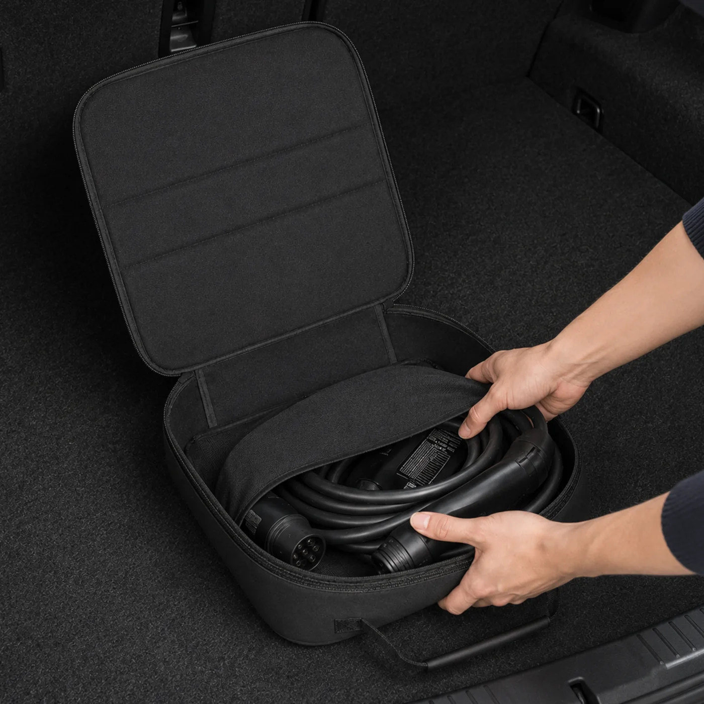 The Kovolt Case open in a car boot with a coiled Type 2 charging cable inside.